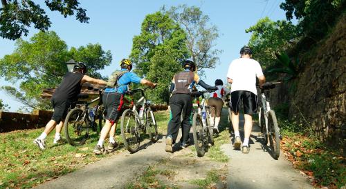 a group of people riding bikes on a path at Blackberry Hills Munnar Nature Resort & Spa in Munnar