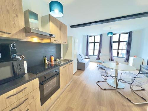 a kitchen with a table and a dining room at Cosy appart- 4 pers Netflix Hyper centre Douai in Douai