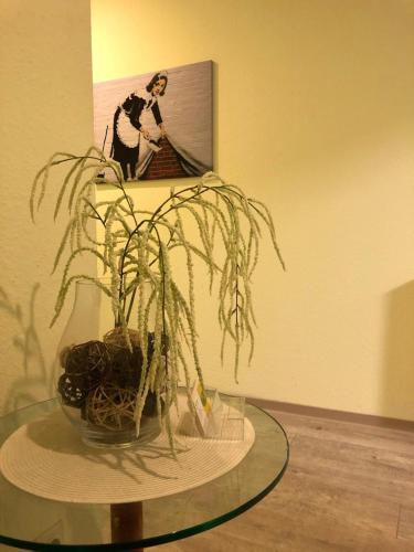 a glass table with a plant on top of it at Monteur-Zimmer Winter in Castrop-Rauxel