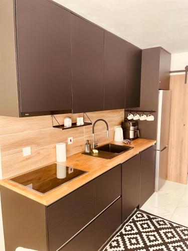 a kitchen with a sink and wooden counter top at Seagarden Hideaway - 1bed apt in Paphos