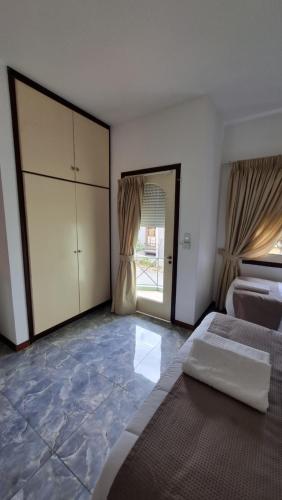 a bedroom with a bed and a large window at Hotel Perla del Plata in Colonia del Sacramento