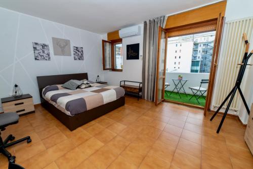 a bedroom with a bed and a large window at RobertONE guest house 14 in Bari