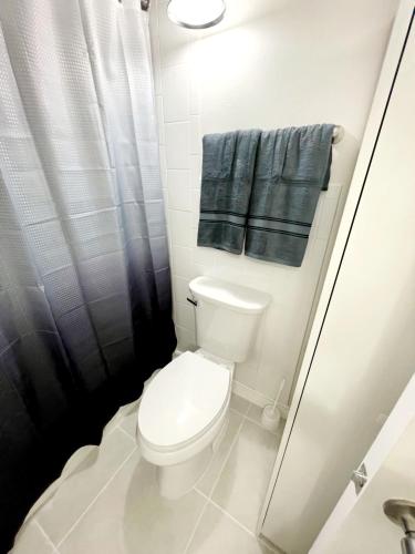 a small bathroom with a toilet and a shower at Daytona Ocean View Modern Studio in Daytona Beach