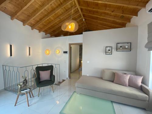 a living room with a couch and a chair at Yataki Cozy House in Plomarion