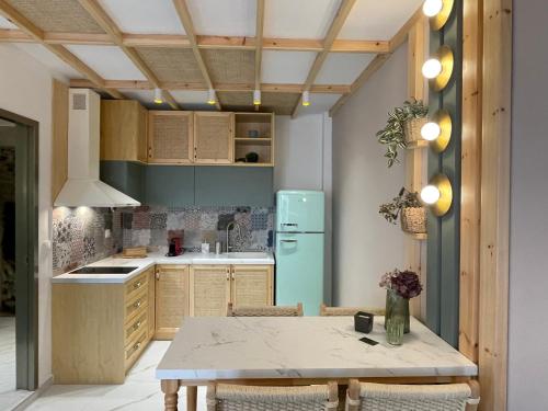 a kitchen with a table and a refrigerator at Yataki Cozy House in Plomarion
