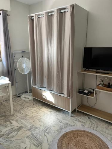 un salon avec un rideau de douche et une télévision dans l'établissement Studio meublé proche plages et vieille ville, à Antibes