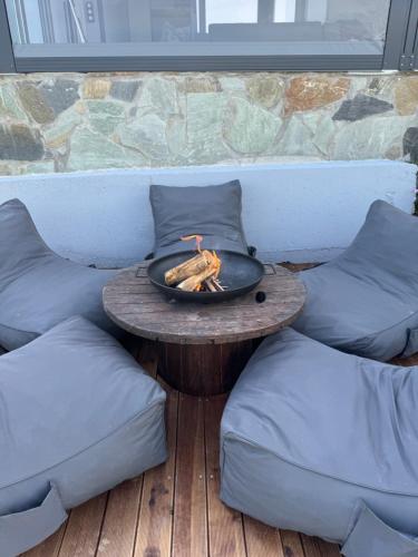 a table with a fire in a bowl on a patio at Spemaré Residence Halkidiki in Nea Kalikratia