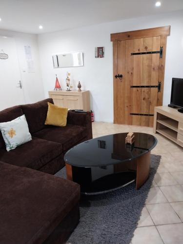 a living room with a couch and a coffee table at Gite Albert in Scrignac
