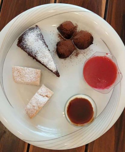 a white plate with desserts on a table at MAWA in Ferrara