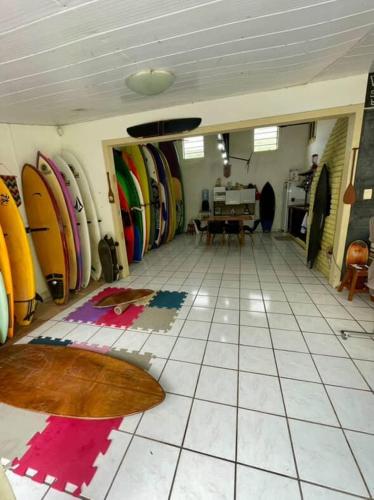 a room with surfboards lined up on the floor at WATERMAN Surf Camp Hospedagem e Escola de Surf, Kitesurf, SUP em Florianópolis in Florianópolis