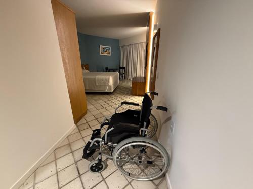 a wheelchair sitting in a hallway with a bedroom at HOTEL PIRÂMIDE NATAL in Natal