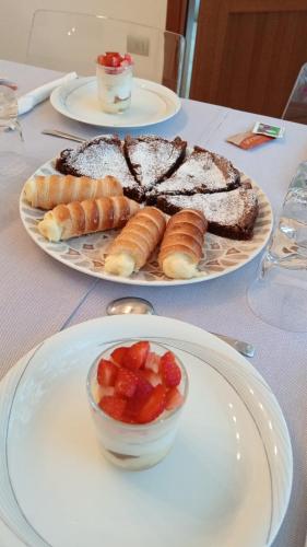 a table with two plates of food and a bowl of fruit at MAWA in Ferrara