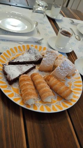 a plate of bread and pastries on a table at MAWA in Ferrara