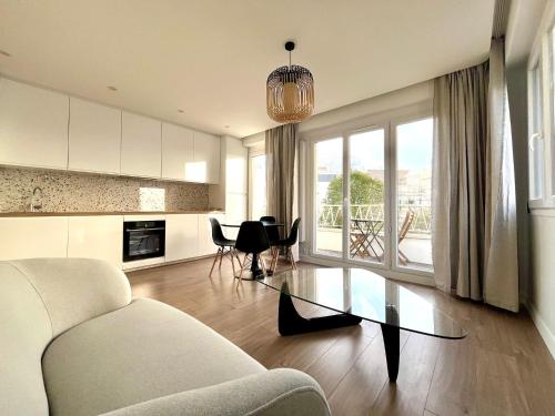 a living room with a couch and a table at Pauline in Neuilly-sur-Seine