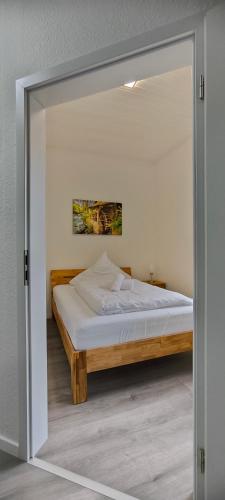a bedroom with a bed through a glass door at Diemeltal Lodge Appartment III in Marsberg