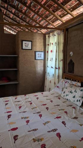 a bedroom with a large bed with flowers on it at The Kesar Home Stay in Maheshwar