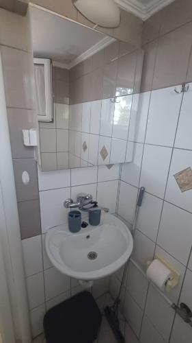 a bathroom with a sink with two blue cups on it at christos cottage! comfortable and quiet! in Keramotí