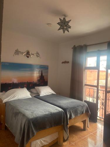 a bedroom with a bed with a star on the wall at La Catrina Hostel in San Miguel de Allende