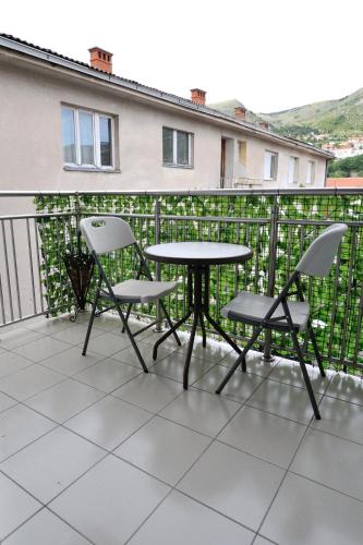 a patio table and chairs on a balcony at Motel Edem in Mostar