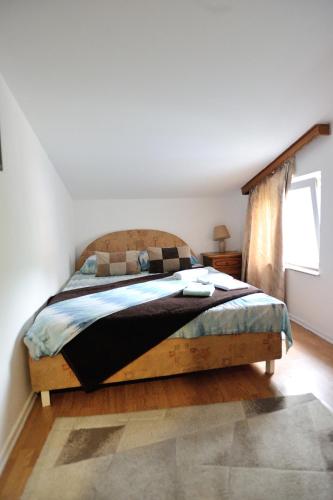 a bedroom with a bed in a room with a window at Motel Edem in Mostar