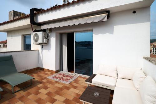 a living room with a couch on a balcony at Ramblas Vendrell in El Vendrell
