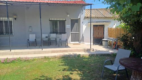a patio with a table and chairs in a yard at christos cottage! comfortable and quiet! in Keramotí
