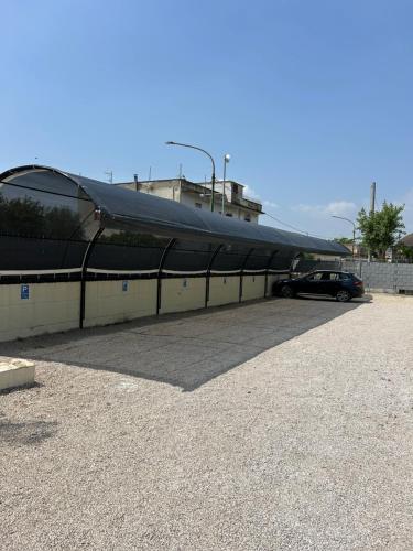 a building with a black covering over a parking lot at La casa dei Coloni in Nola