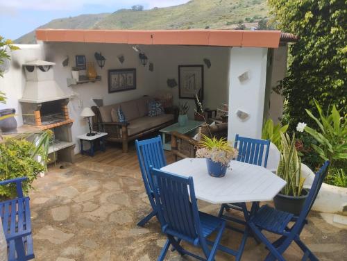 a patio with a table and chairs and a couch at Casa del Mir 2 in Tegueste