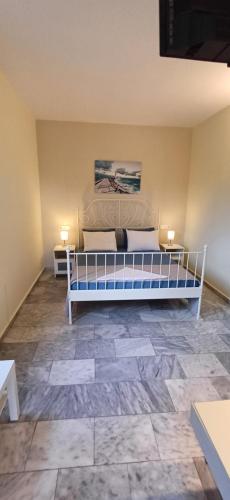 a bedroom with a bed and two lamps on the floor at Villa Kavourakia in Kolios