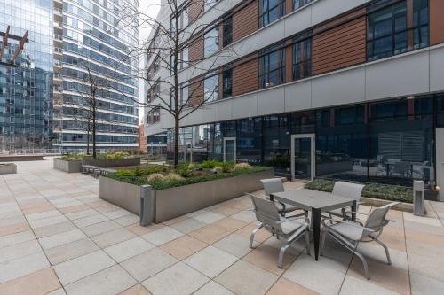 a patio with a table and chairs in front of a building at Private Apt Downtown Seaport in Boston