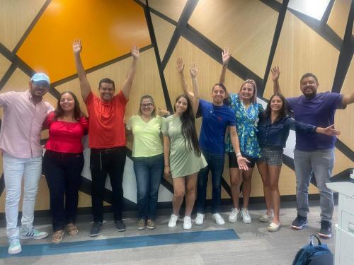 a group of people standing in a room with their hands in the air at test hotel in Guadalajara