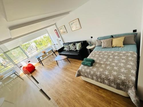 a bedroom with a bed and a living room at TrendyHomes Aguadulce Bay II in Aguadulce