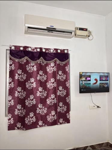 a room with a curtain and a air conditioner at Zia Residency and Villa in Puducherry