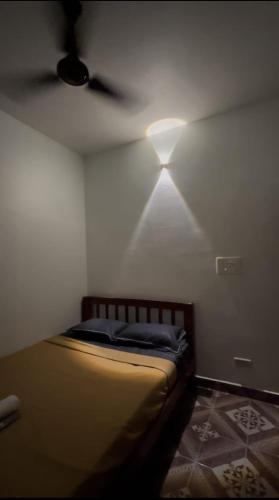 a bedroom with a bed with a ceiling fan at Zia Residency and Villa in Puducherry