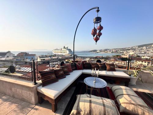a rooftop patio with couches and a view of the city at Villa Ephesus Hotel in Kusadası