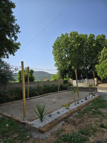 un parc avec un banc, des arbres et une clôture dans l'établissement Partie privative dans villa 6 personnes piscine climatisé, aux Arcs-sur-Argens