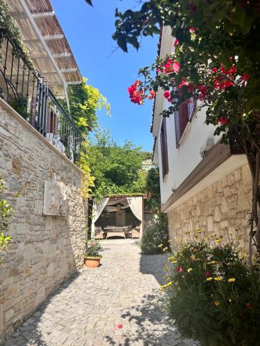 a stone alley with a bench in a building at Villa Ephesus Hotel in Kusadası