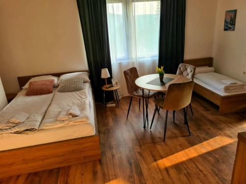 a bedroom with a bed and a table with chairs at Whispering Pines in Šišava