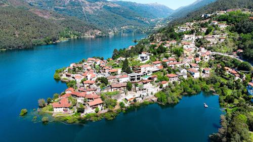 an island in the middle of a river with houses at Casa da Pipa in Geres