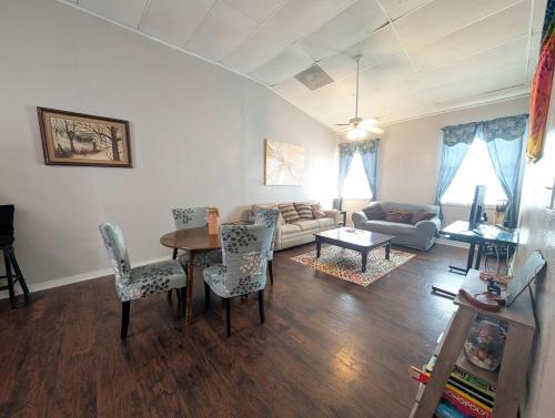 a living room with a table and chairs and a couch at Chapel in Ingleside