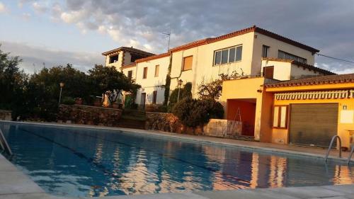 a house and a swimming pool in front of a house at Mas Pericay in Pals