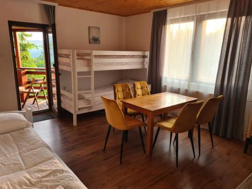 a bedroom with a table and chairs and a bed at Whispering Pines in Šišava