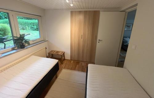 a small room with a bed and a window at Holiday Home 36A BÅSTAD in Båstad