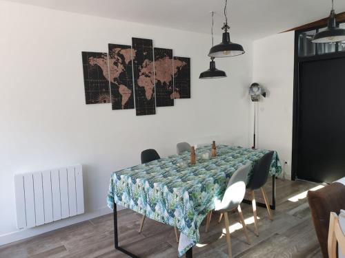 a dining room table with chairs and a tablecloth on it at L'Atelier in Auxerre