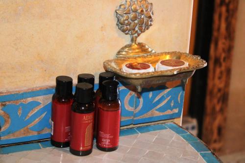 a group of four bottles of sauce next to a pizza at Dar Diafa Kaltom in Ouzoud