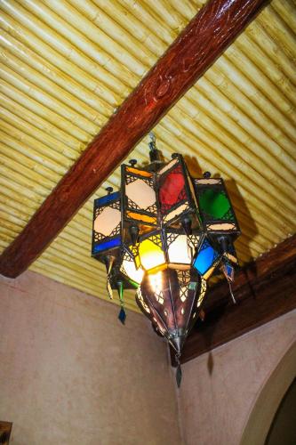 a stained glass chandelier hanging from a ceiling at Dar Diafa Kaltom in Ouzoud