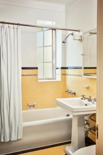 a bathroom with a tub and a sink and a bath tub at Chateau Marmont in Los Angeles