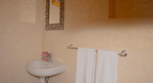 a bathroom with a sink and a toilet and towels at Bab Jbel in Ourika
