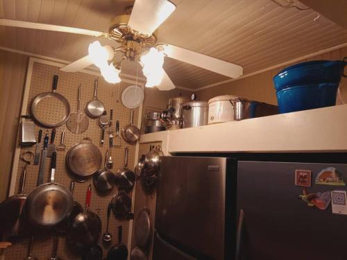 a kitchen with pots and pans hanging on the wall at 10 Mi to Gore Mountain- Home in Adirondack Park home in Olmstedville