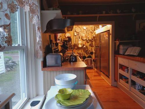 a kitchen with a table with a plate of food at 10 Mi to Gore Mountain- Home in Adirondack Park home in Olmstedville